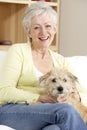 Senior Woman Holding Dog On Sofa Royalty Free Stock Photo