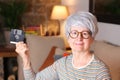 Senior woman holding floppy disk Royalty Free Stock Photo