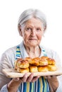 Senior woman holding fresh buns over white Royalty Free Stock Photo