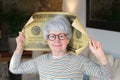 Senior woman holding gigantic 100 dollars bill Royalty Free Stock Photo