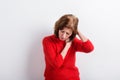 Senior woman holding head, having headache. Studio shot. Royalty Free Stock Photo
