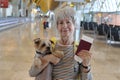 Senior woman holding her pet passport