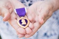 Senior Woman Holding The Military Purple Heart Medal In Her Hand Royalty Free Stock Photo