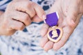 Senior Woman Holding The Military Purple Heart Medal In Her Hand Royalty Free Stock Photo