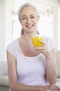 Senior Woman Holding Orange Juice And Smilng Royalty Free Stock Photo