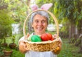 Senior woman holding out Easter basket Royalty Free Stock Photo