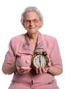 Senior Woman Holding Piggy Bank and Clock Royalty Free Stock Photo