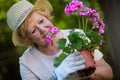 Senior woman holding pot plant in garden Royalty Free Stock Photo