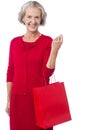 Senior woman holding red shopping bag Royalty Free Stock Photo