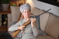 Senior woman holding a rifle