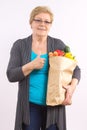 Senior woman holding shopping bag with fruits and vegetables and showing thumbs up, healthy nutrition in old age Royalty Free Stock Photo