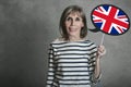 Senior woman holding a sign with the English flag Royalty Free Stock Photo
