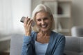 Senior woman holding smartphone listening voice message Royalty Free Stock Photo