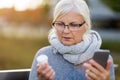 Woman holding smartphone and pill bottle Royalty Free Stock Photo