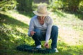 Senior woman holding snail in garden Royalty Free Stock Photo