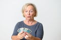 Senior Woman Holding Tarot Cards Against Gray Wall