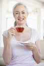 Senior Woman Holding Tea And Smiling At The Camera Royalty Free Stock Photo
