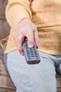 A senior woman holding (using) remote control Royalty Free Stock Photo