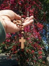 Senior woman holding wooden  rosary in hand with Jesus Christ Cross Crucifix. Christian Catholic religious symbol of faith concept Royalty Free Stock Photo