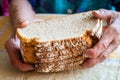 Senior woman holds several slices of dry bread in her old worn hands, Concept, plight of pensioners and poor people