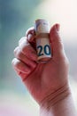 Senior woman holds twenty euro notes roll in old hand Royalty Free Stock Photo