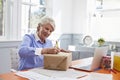 Senior Woman At Home Addressing Package For Mailing Royalty Free Stock Photo