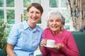 Senior Woman At Home With Carer