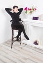 Senior woman at home sitting on modern chair and relaxing Royalty Free Stock Photo