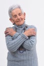 Senior woman hugging on white background