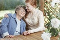 Senior woman hugs young assistant Royalty Free Stock Photo