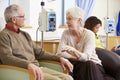 Senior Woman With Husband During Chemotherapy Treatment