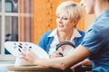 Senior woman with impairment choosing hearing aid