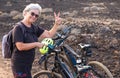 Senior woman enjoying outdoor excursion with electric bicycle, smiling and doing ok with hand Royalty Free Stock Photo