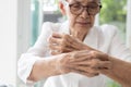 Senior woman with itchy,scratching her arm,dryness and itching,affect of certain medications,dry skin or trigger allergic