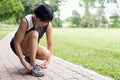 Senior jogger tighten her running shoe laces