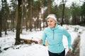 Senior woman jogging in winter nature. Royalty Free Stock Photo