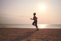 Senior woman jogging on sea beach Royalty Free Stock Photo