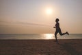 Senior woman jogging on sea beach Royalty Free Stock Photo