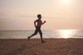 Senior woman jogging on sea beach Royalty Free Stock Photo