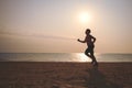 Senior woman jogging on sea beach Royalty Free Stock Photo