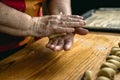 Senior woman kneading pastry dough in hands Royalty Free Stock Photo