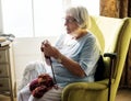 Senior woman knitting for hobby at home Royalty Free Stock Photo