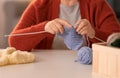 Senior woman knitting warm sock at table Royalty Free Stock Photo