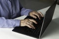 Senior gray-haired woman with laptop. Elderly woman writing memoirs on laptop, searching for information on the Internet or