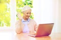 Senior woman with laptop having video chat at home Royalty Free Stock Photo