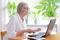 Senior woman laptop tax declaration Royalty Free Stock Photo