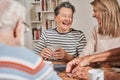 Senior woman laughing out loud while sitting at the table with her caregiver Royalty Free Stock Photo