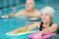 senior woman learning to swim in pool Royalty Free Stock Photo