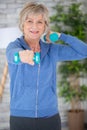 senior woman in lifting dumbell at retirement home Royalty Free Stock Photo