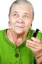 Senior woman listening music at mobile phone Royalty Free Stock Photo